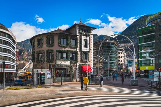 Andorra la Vella, Andorra, Jan 2020 People on duty free shopping, street with modern shops and restaurants in capital city, Pyrenees Mountains