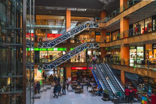 Andorra la Vella, Andorra, Jan 2020 Crowd of people shopping in multi floor shopping mall or a gallery in a capital city. Pyrenees Mountains