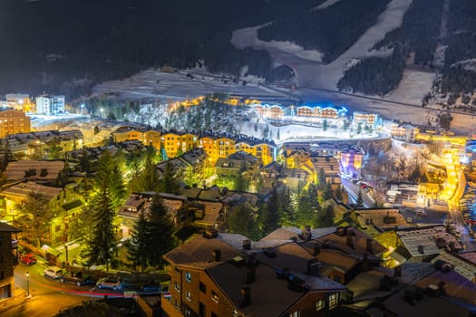 Long exposure, night photography of beautiful El Tarter town illuminated by street lights. Ski winter holidays in Andorra, Pyrenees