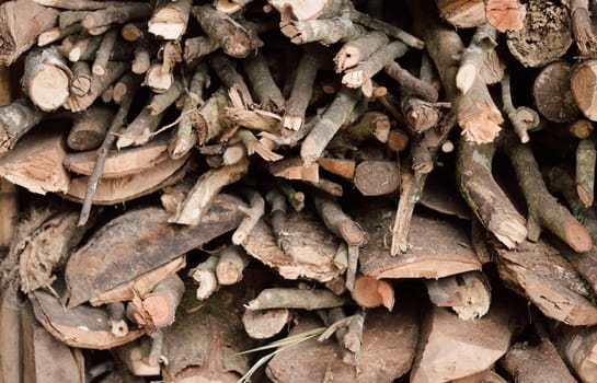 Stack of chopped firewood abstract background.