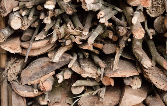 Stack of chopped firewood abstract background.
