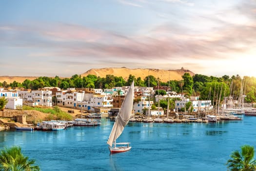 Picturesque buildings of Aswan, the Nile and sailboats, Egypt.