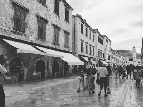 Stradun, Stradone is the main street of the historic city center of Dubrovnik in Croatia. architectural sights. A popular place for tourist walks. People are walking August 14, 2022 Black and white.