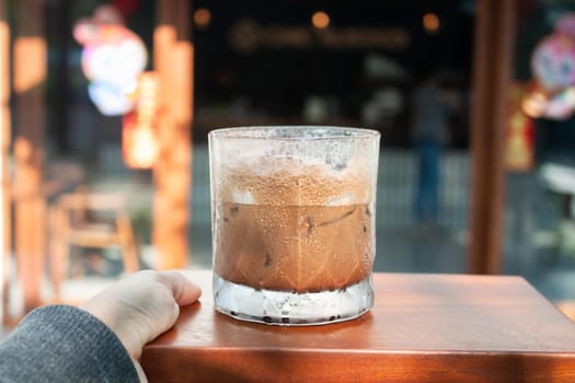 Iced coffee with micro foam in coffee shop, stock photo