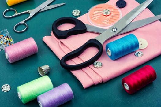 Home sewing kit, scissors, set needles, buttons and threads. Sewing items
