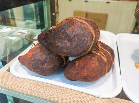 Extremaduran buche displayed at butchers shop. Pork stomach stuffed with ribs, tail, tongue and snout