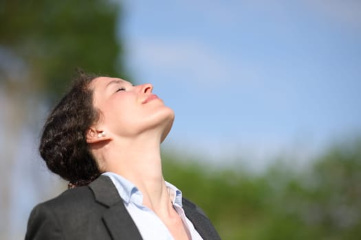 Businesswoman breathing fresh air
