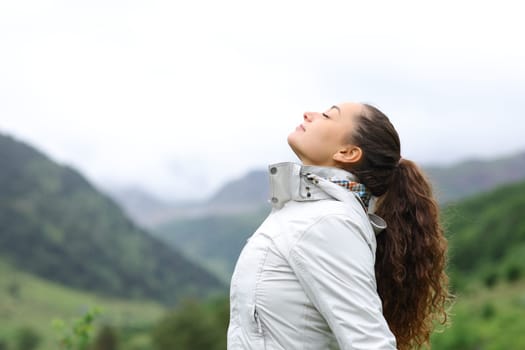 Profile of a hiker breathing fresh air in nature