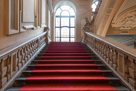 Turin, Italy - January 2023: Palazzo Barolo staircase. Luxury palace with old baroque interior and red carpet
