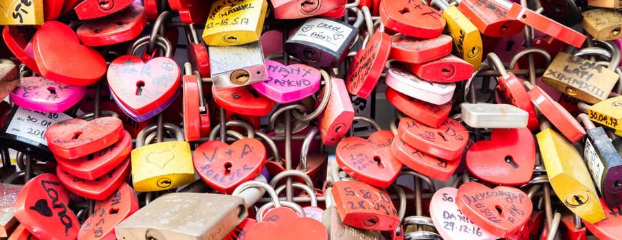 Verona, Italy - June 2022: background of heart-shaped locks on a wall, symbol of love forever