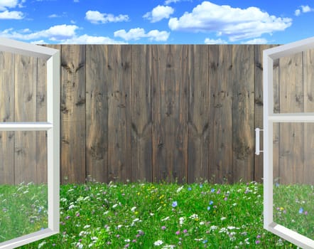 Open window overlooking the fence. Window overlooking the summer courtyard with wooden fence. View from the window. Opened window overlooking green grass in courtyard in summer