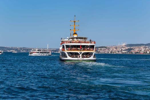 Istanbul - August 01, 2022: Ferry boat on Bosphorus Strait in Istanbul, Turkey. Istanbul is a major city in Turkey.