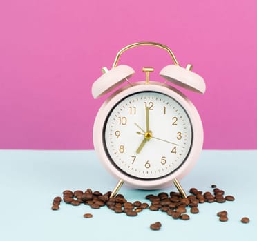 Alarm clock with roasted coffee beans, wake up in the morning, time to stand up, hot drink for breakfast