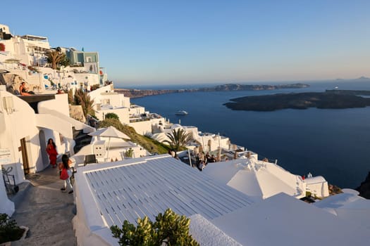 Imergovigli, Santorini, Greece - June 29, 2021: Whitewashed houses with terraces and pools and a beautiful view in Imerovigli on Santorini island, Greece