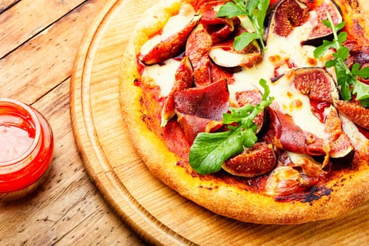 Homemade meat pizza with figs. Flatbread with figs, copy space