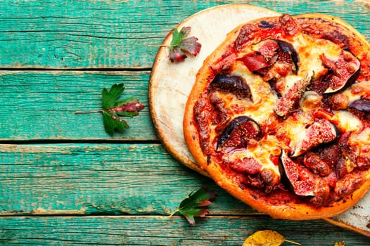 Homemade meat pizza with figs. Flatbread with figs, copy space