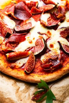 Homemade meat pizza with figs. Flatbread with figs, copy space