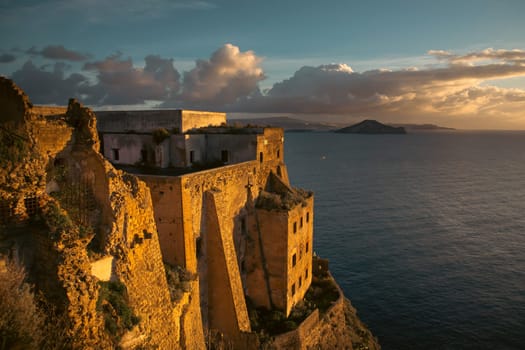 Beautiful seascape from the Island of Procida. View of the Avalos Castle and the Vesubio Volcano in the rear. Campania. Italy.