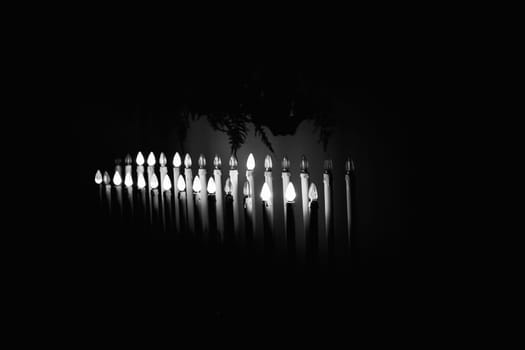 Many burning candles with shallow depth of field in a church