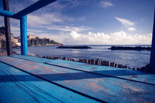 Wooden pier, exotic sea and a blue sky. Beautiful summer background. Vacation and traveling concept.