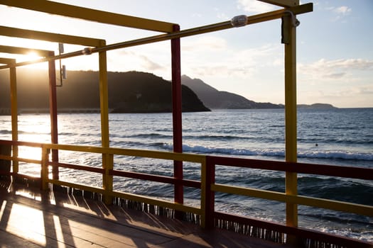 Cozy terrace on the beach, idyllic view of the seashore. Tropical summer vacation concept.