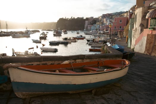 View of the Port of Corricella with lots of colorful houses on a sunny day in Procida Island, Italy.