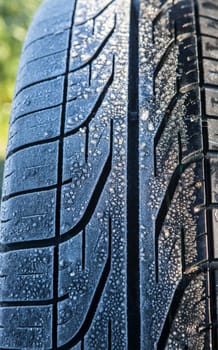 Frost covered tire surface. Safe driving on winter concept