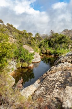 Andringitra national park, Haute Matsiatra region, Madagascar, beautiful mountain landscape with small river lagoon in valley. Hiking in Andringitra mountains. Madagascar wilderness landscape.