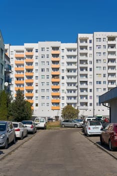 City view of Swinoujscie in Poland with prefabricated buildings and parked cars in the city center