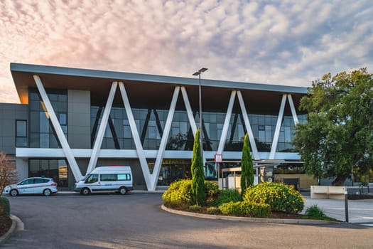 Perpignan, France, Jan Building, exterior of Perpignan Rivesaltes Mediterranean airport with decorative trees and bushes at dramatic sunrise