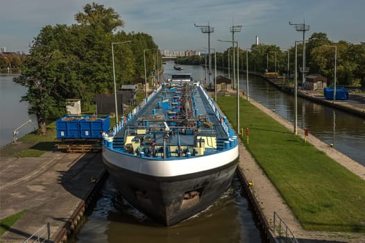 A cargo ship enters the Griesheim lock, Frankfurt, Germany