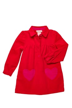 Summer dress isolated. A beautiful red girl's dress with attached heart shaped pockets and long sleeves isolated on white. Clipping path. Kids spring and autumn fashion.