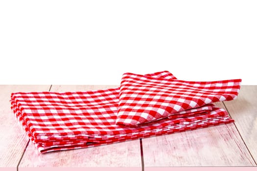 Empty wooden bright desk table with red checkered tablecloth isolated on a white background. Template for your food and product display montage.