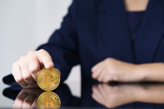 Close-up of finger touching golden bitcoin coin. Cryptocurrency and future money concept
