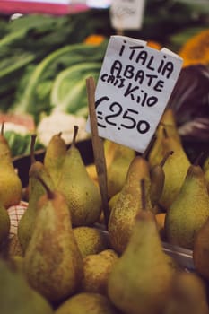 Venice, Italy, November 2014: Italian Abate pears with price tag for sale in a market stall.