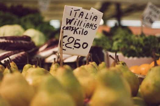 Venice, Italy, November 2014: Italian Williams pears with price tag for sale in a market stall. Selective focus.