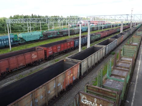 Svir, Russia August 6, 2021. Freight trains and wagons from above. Railroad on a summer day. Transportation, cargo, logistics and business process. Empty metal wagons. International cargo transport.