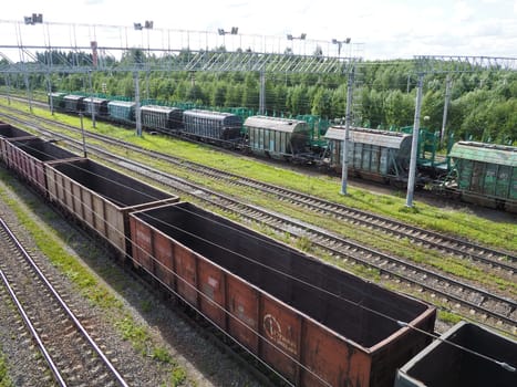 Svir, Russia August 6, 2021. Freight trains and wagons from above. Railroad on a summer day. Transportation, cargo, logistics and business process. Empty metal wagons. International cargo transport