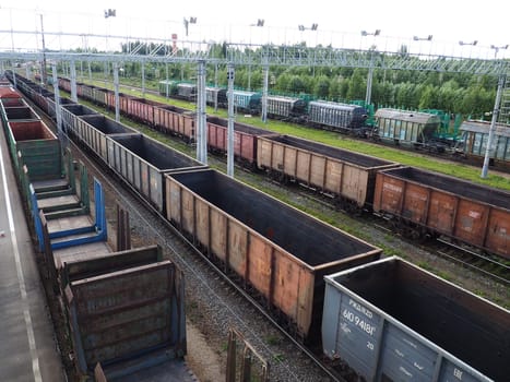 Svir, Russia August 6, 2021. Freight trains and wagons from above. Railroad on a summer day. Transportation, cargo, logistics and business process. Empty metal wagons. International cargo transport.