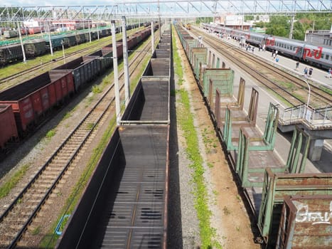 Svir, Russia August 6, 2021. Freight trains and wagons from above. Railroad on a summer day. Transportation, cargo, logistics and business process. Empty metal wagons. International cargo transport.