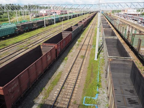 Svir, Russia August 6, 2021. Freight trains and wagons from above. Railroad on a summer day. Transportation, cargo, logistics and business process. Empty metal wagons. International cargo transport.