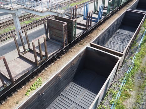 Svir, Russia August 6, 2021. Freight trains and wagons from above. Railroad on a summer day. Transportation, cargo, logistics and business process. Empty metal wagons. International cargo transport.