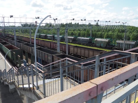 Svir, Russia August 6, 2021. Freight trains and wagons from above. Railroad on a summer day. Transportation, cargo, logistics and business process. Empty metal wagons. International cargo transport.