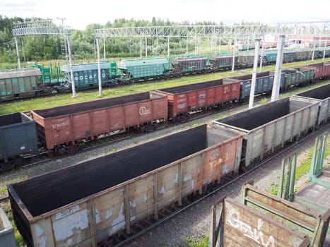Svir, Russia August 6, 2021. Freight trains and wagons from above. Railroad on a summer day. Transportation, cargo, logistics and business process. Empty metal wagons. International cargo transport.