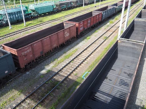 Svir, Russia August 6, 2021. Freight trains and wagons from above. Railroad on a summer day. Transportation, cargo, logistics and business process. Empty metal wagons. International cargo transport.