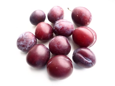 plums on a white background. Juicy ripe fruits.