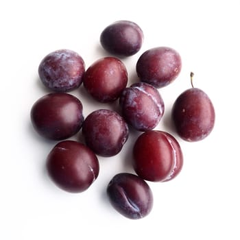 plums on a white background. Juicy ripe fruits.