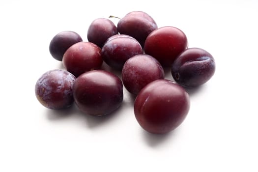 plums on a white background. Juicy ripe fruits.