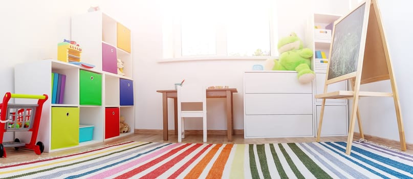 Comfortable room with colourful furniture in sunny day. Concept of the child room and kindergarten.