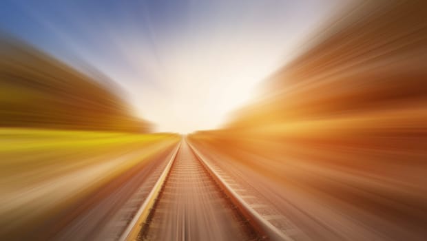 Blurred effect of the railroad in nature in evening. Concept of transportation and logistic.